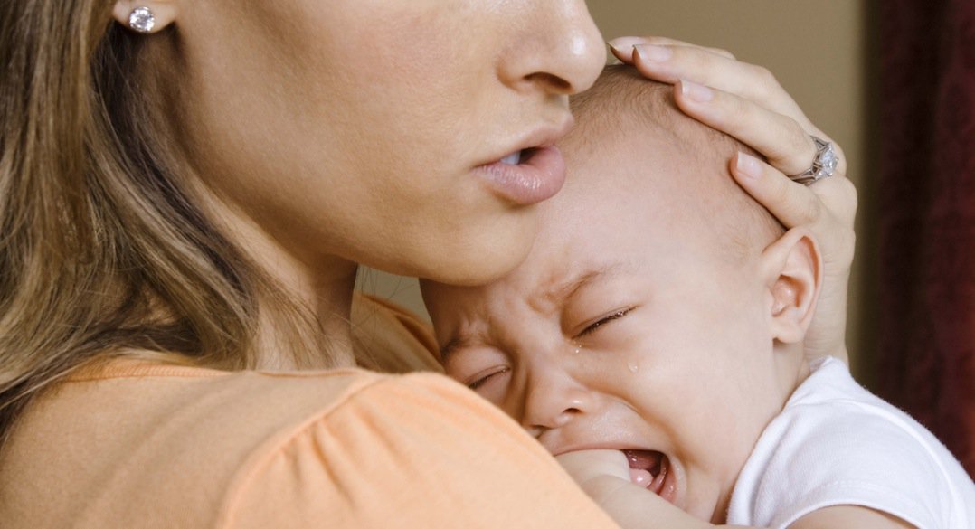 Mother consoling her crying baby