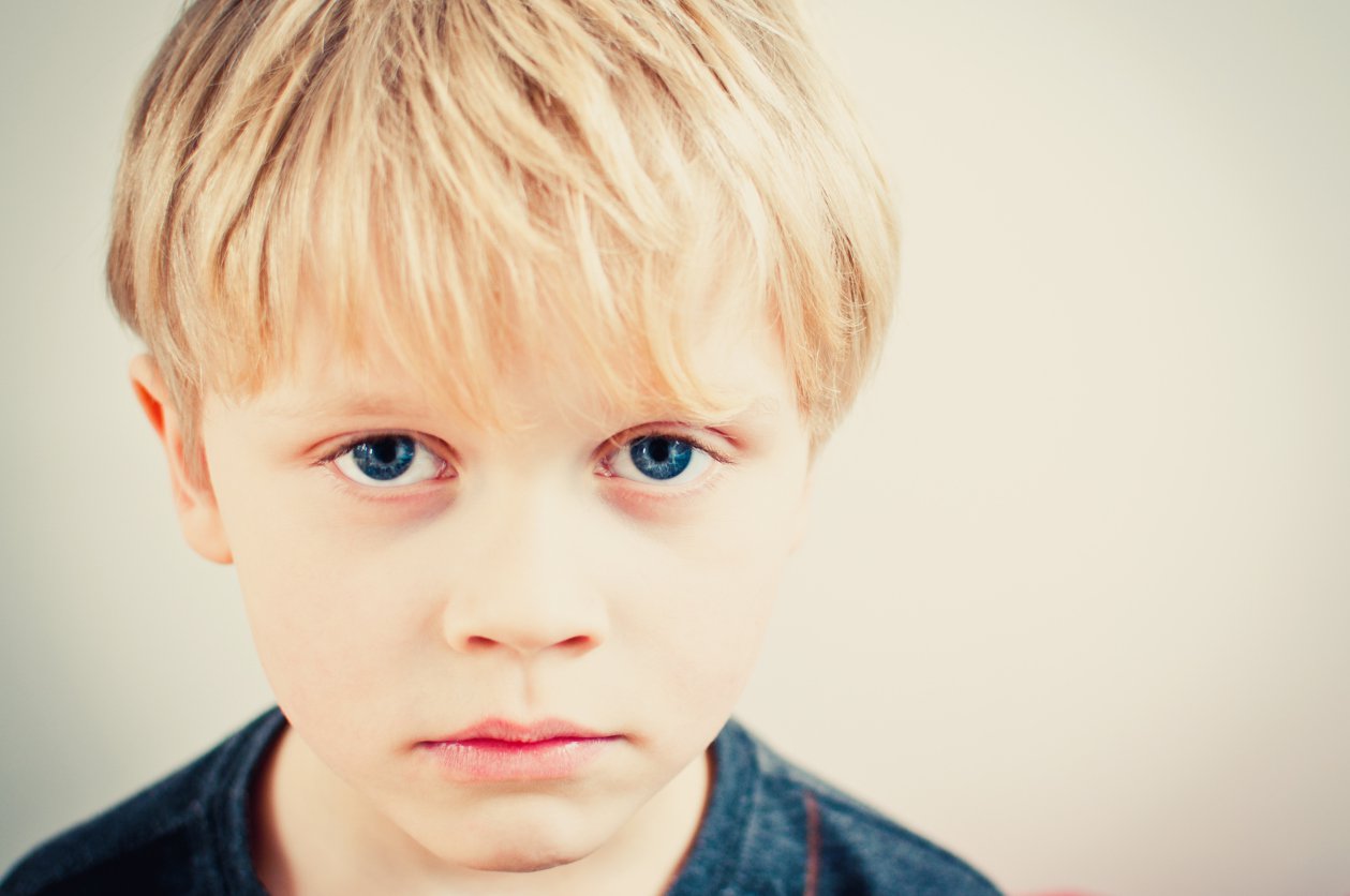 Close up of young child looking morose