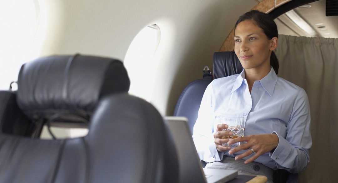 Hispanic businesswoman on airplane