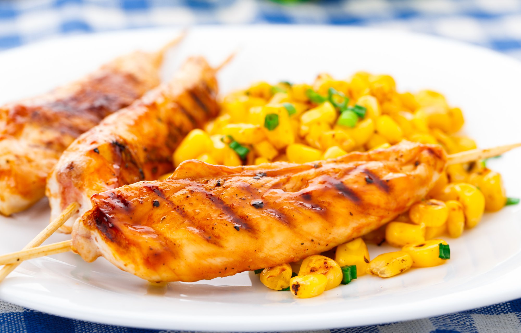 Honey chicken skewers with grilled corn salad