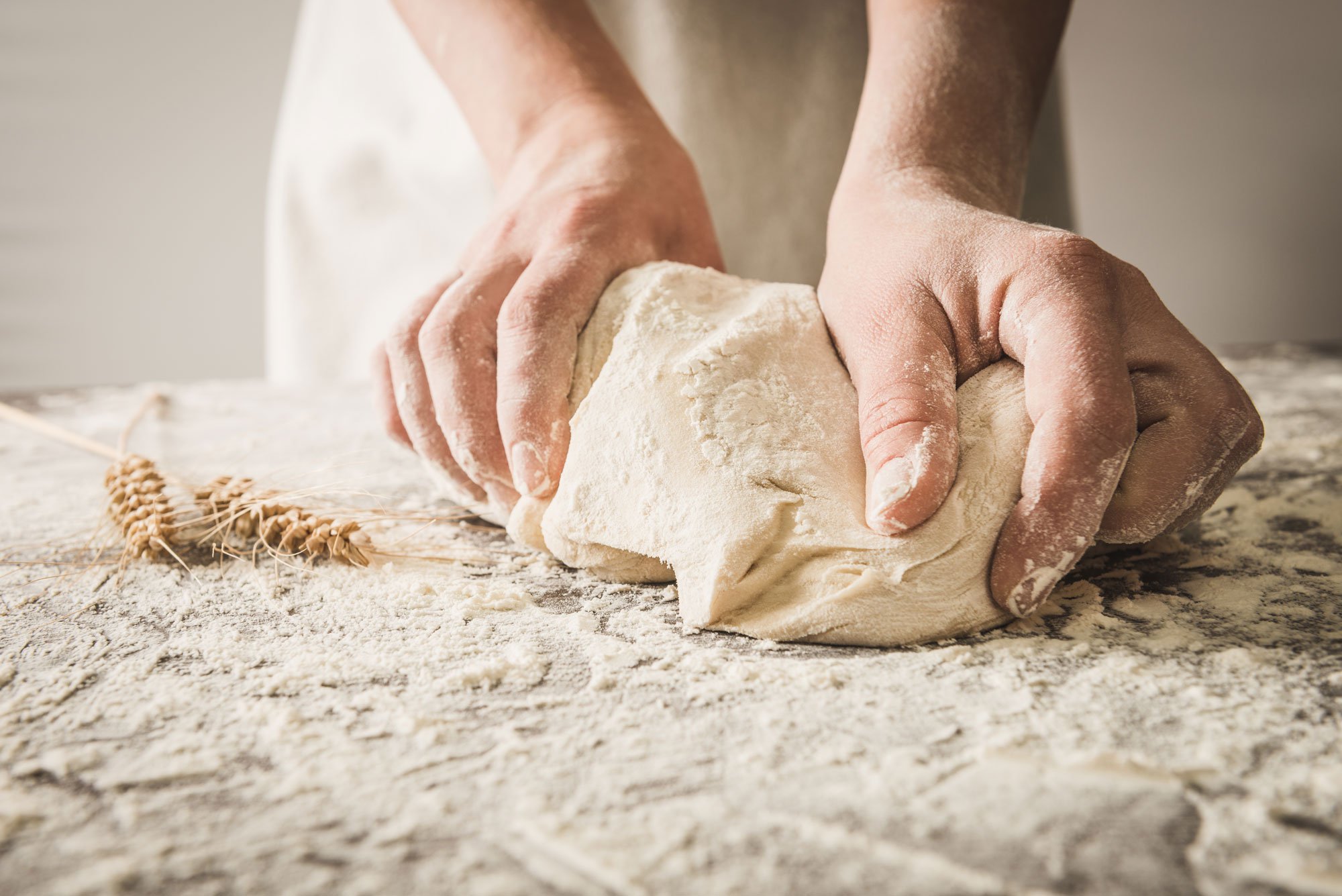 Hands rolling dough