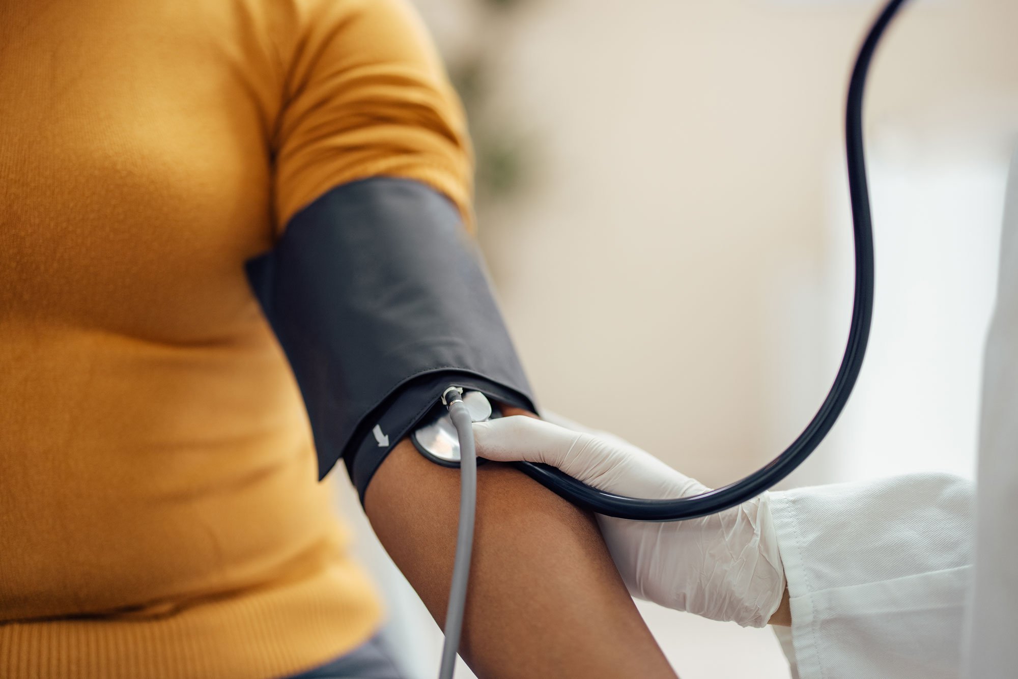 Close up of a blood pressure cuff around woman's arm