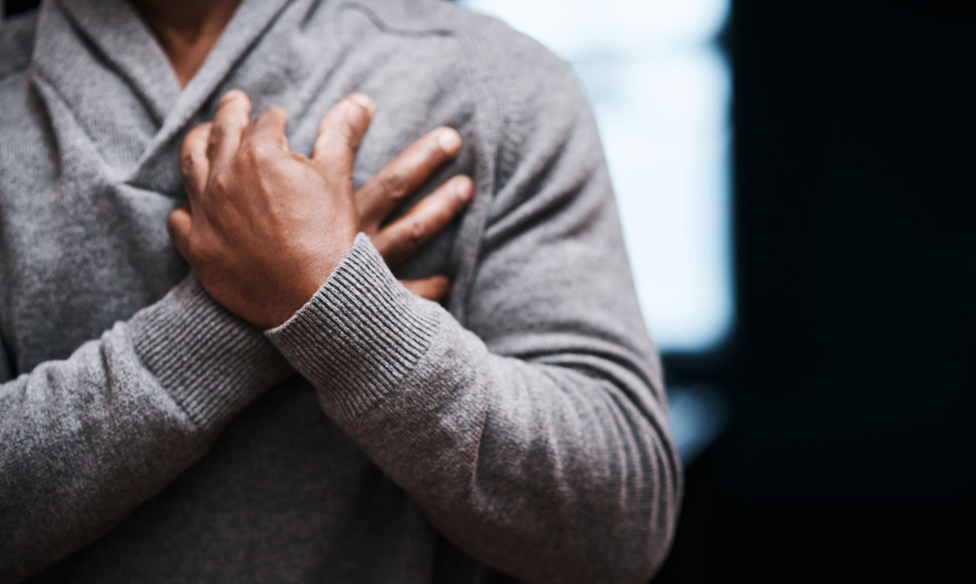 Man holding his hands at his chest