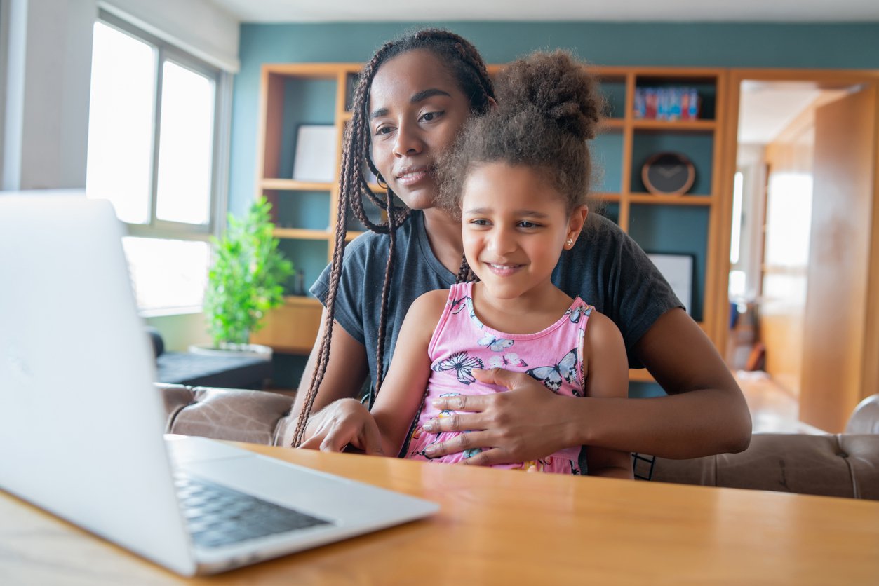 Mother and daughter telehealth on laptop