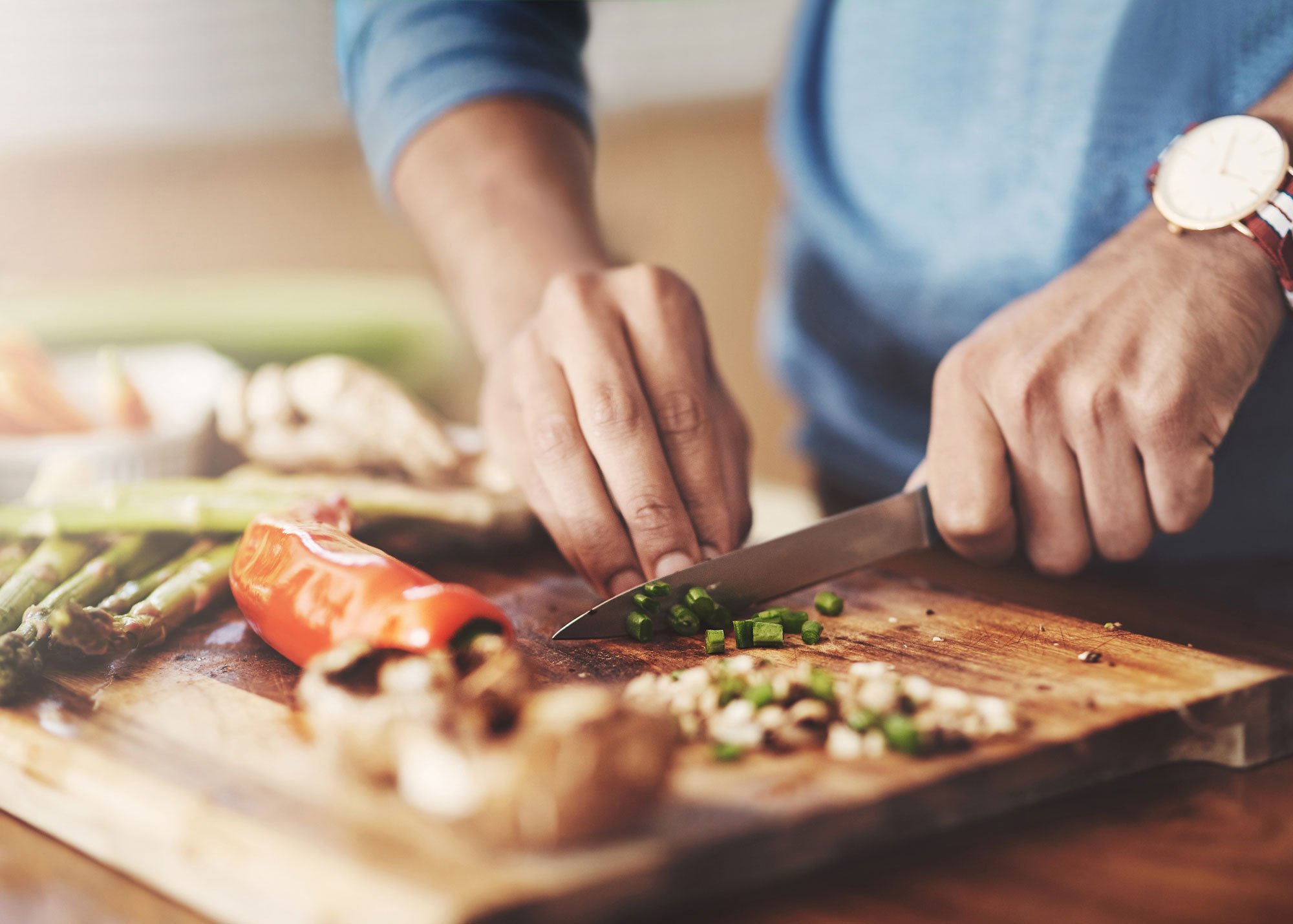 Close-up photo of man chopping vegetables