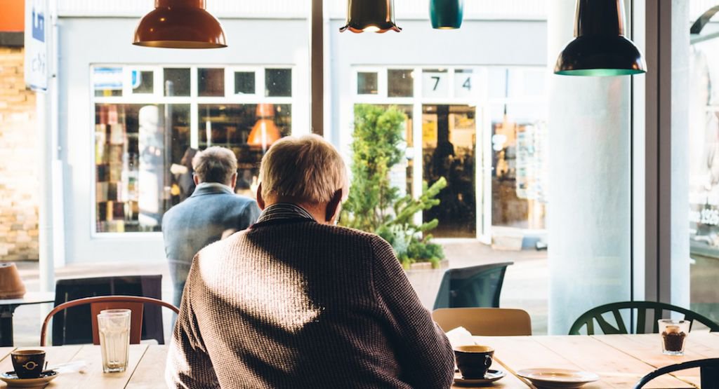 Man sitting at a table in a cafe