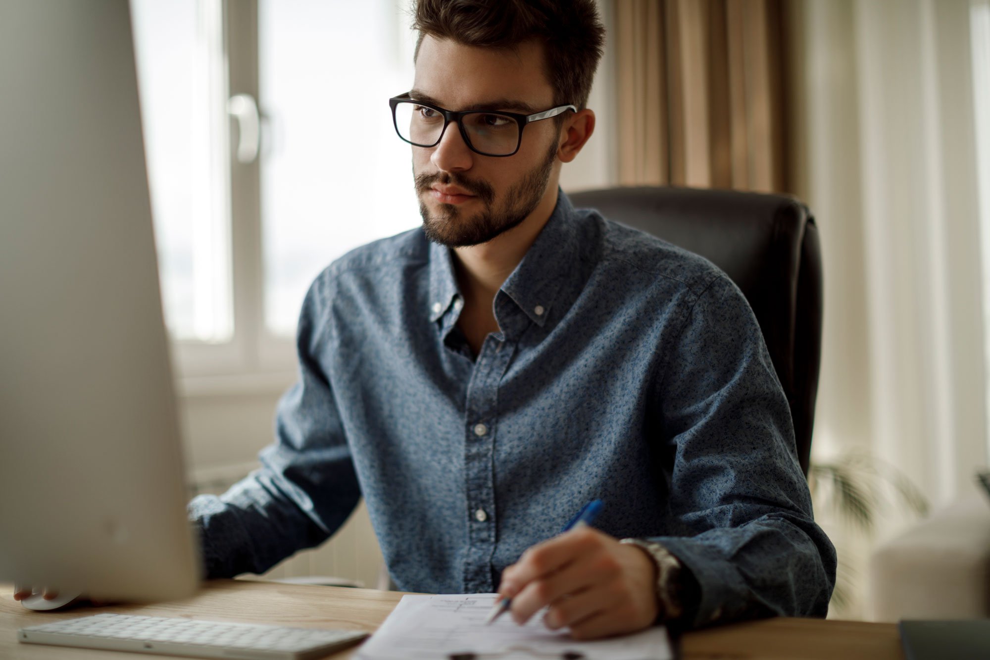 man signing paper