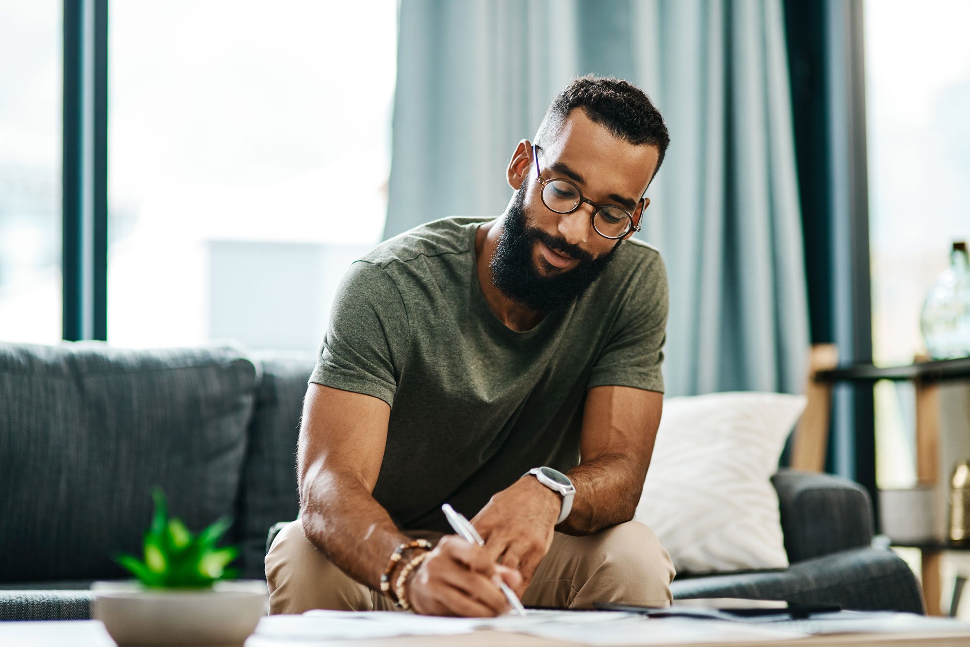 man signing papers