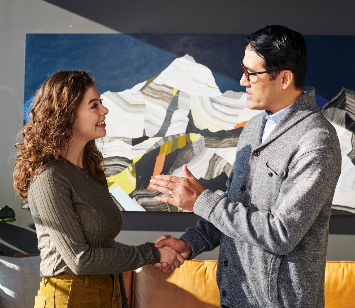 A provider and a patient shaking hands in a One Medical office
