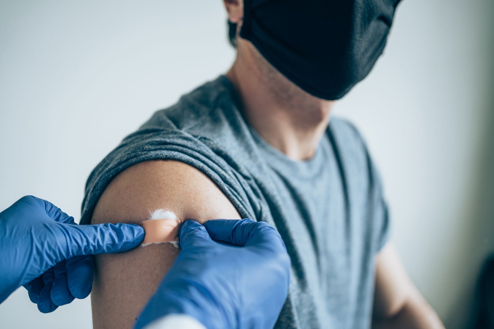 Doctor putting a bandage on a man's arm