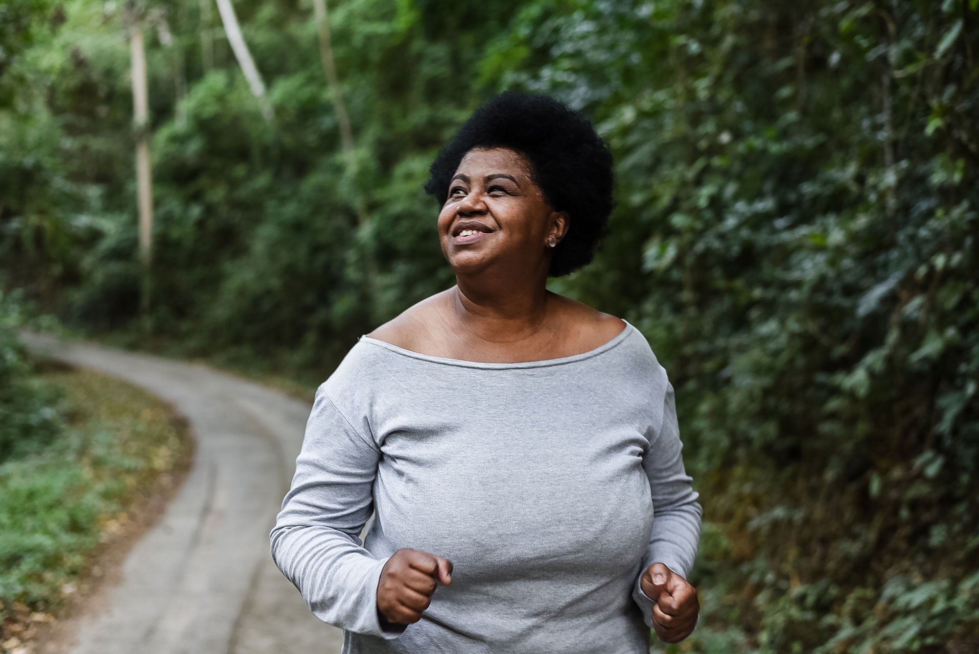 Middle aged woman strolling through park