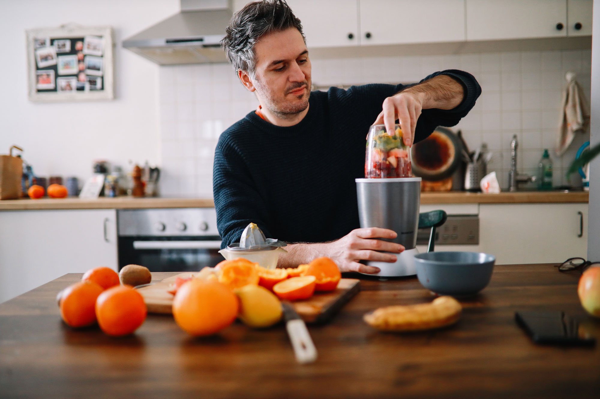 Man cutting fruit for a smoothie