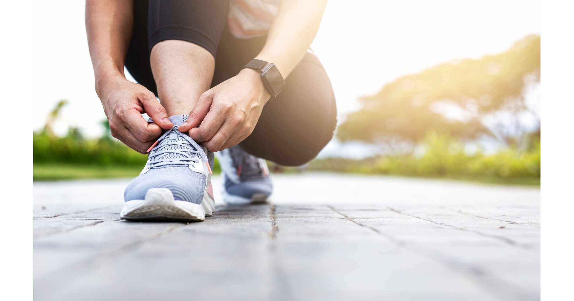 Person tying shoes outdoors