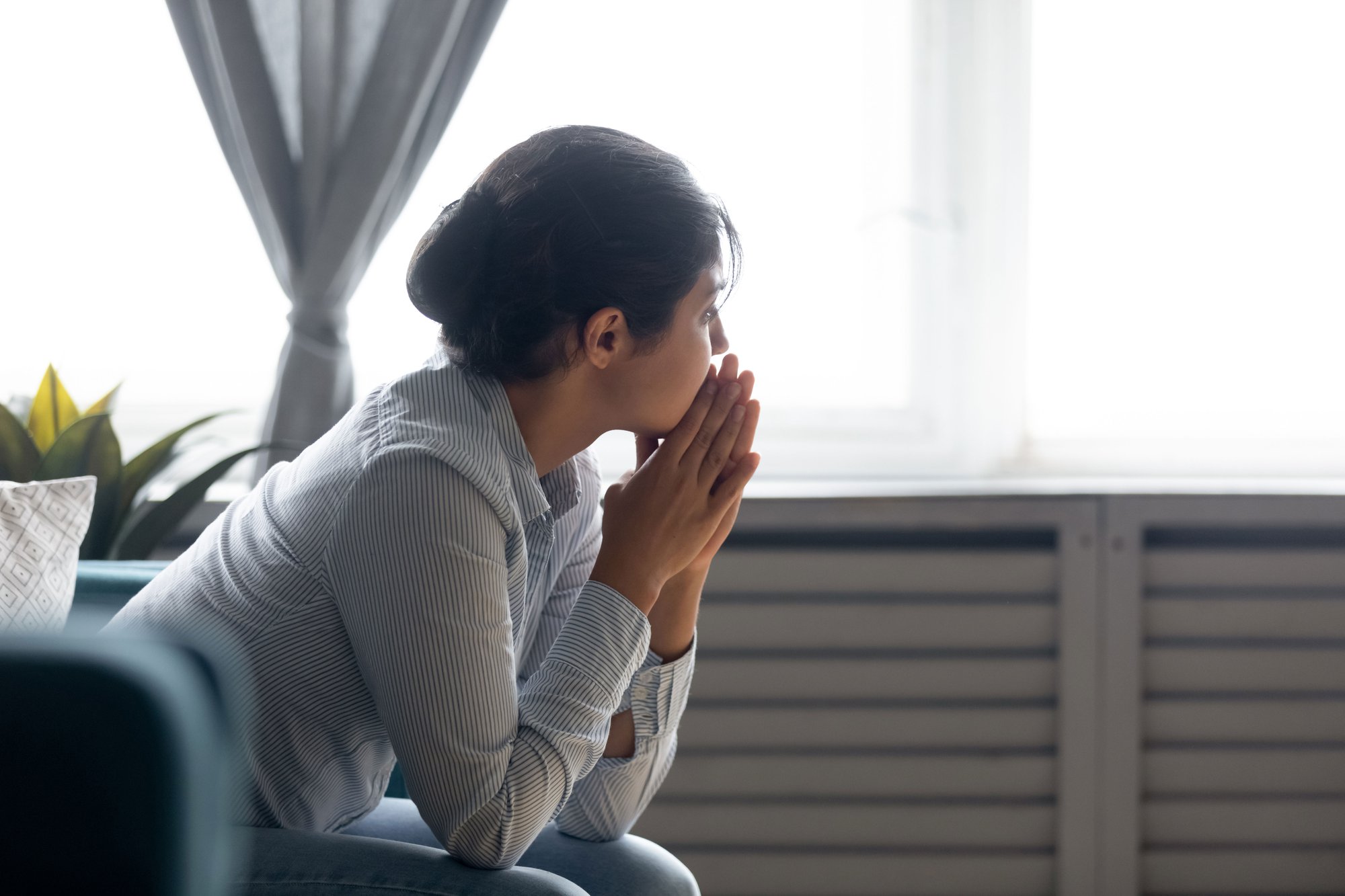 Woman staring pensively out window