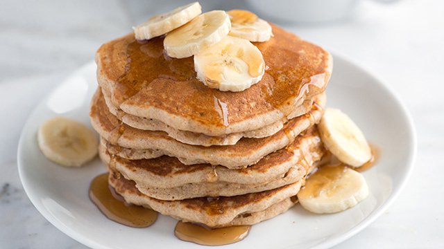 Stack of whole wheat pancakes with bananas