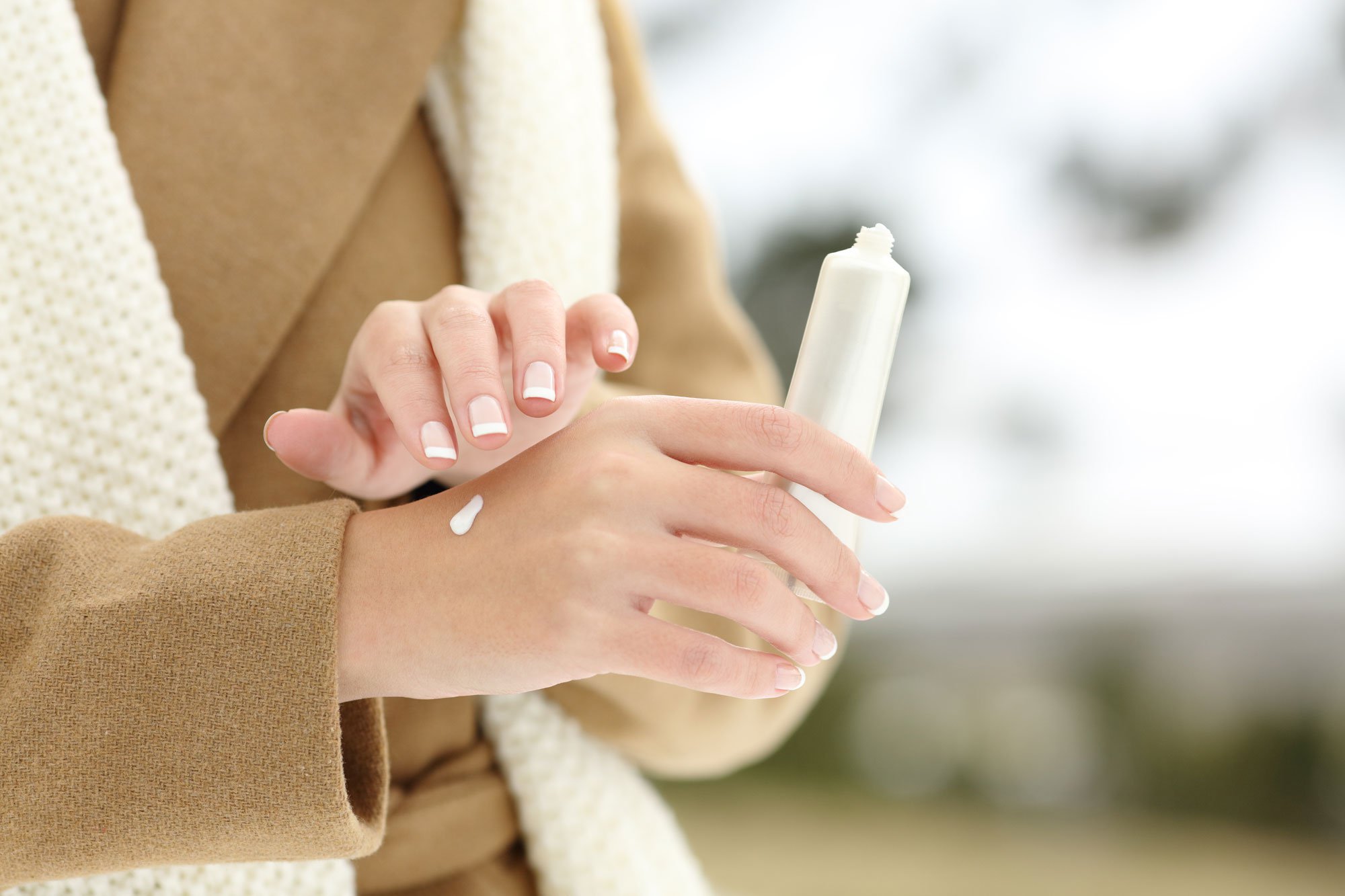 Close up of woman rubbing lotion on her hands